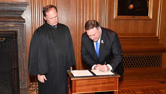 US Secretary of State Mike Pompeo signs his swearing in papers in 2018. Image: Wikimedia Commons Image:US Secretary of State Mike Pompeo signs his swearing in papers in 2018. Image: Wikimedia Commons